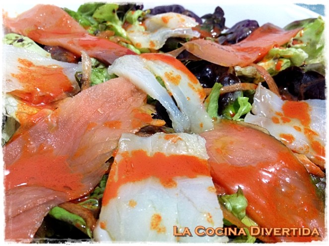 Ensalada de lechuga de hoja de roble con salmón y bacalao ahumado y aceite aromático de zanahoria